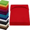 A stack of colorful fitted sheets and a single red fitted sheet. Produktbild-Vorschau