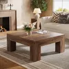 A living room scene with a coffee table, sofa, fireplace, and lamp. Voir les images du produit