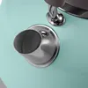A close-up view of the spout and handle attachment of a mint-colored kettle. Voir les images du produit