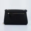 A black Guess crossbody handbag is shown from the back against a white background. Produktbild-Vorschau