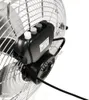 A close-up view of the motor and control panel of a chrome fan. Voir les images du produit