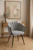 A light gray upholstered chair with a diamond pattern is placed in a room with a wooden console table and artwork on the wall. Produktbild-Vorschau