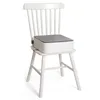 A white wooden chair with a white and gray booster seat for children placed on it. Produktbild-Vorschau