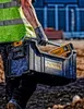 A construction worker carrying a tool box. Podgląd zdjęcia produktu