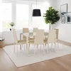 A dining room set with chairs and a table, placed on a rug in front of a large window. Produktbild-Vorschau