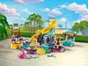A LEGO Friends water park playset with slides, pool, and figures, set against a tropical backdrop. Produktbild-Vorschau