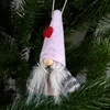 A gnome ornament hanging on a Christmas tree. Produktbild-Vorschau