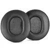 Two black ear pads for headphones are shown against a white background. Voir les images du produit