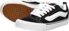 A pair of Vans Knu Skool sneakers shown from a diagonal angle, with one shoe placed slightly behind the other. The shoes are black with white accents and white laces. The sole is white, and the outsole is brown with a waffle pattern. Voir les images du produit