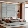 A bed with a large upholstered headboard in a modern bedroom. Anteprima dell’immagine prodotto