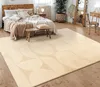 A bedroom scene with a bed, rug, and furniture, showcasing a rug in a Scandinavian Boho style.