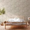 A bedroom scene with a bed, a plant, and a straw hat. Produktbild-Vorschau
