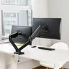 A dual monitor arm mounted on a white desk, with two black monitors attached. Náhled obrázku produktu