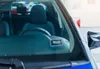 Close-up view of the interior of a car, focusing on a digital parking disc mounted on the dashboard. Produktbild-Vorschau