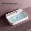 A white ceramic sink filled with water, with a faucet and a swirling water effect indicating drainage. Voir les images du produit