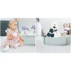 A split image showing a baby playing with balls on the left and a stuffed polar bear in a playpen on the right. Voir les images du produit