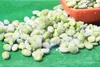 A close-up shot of frozen edamame beans with salt crystals scattered on a green surface. Podgląd zdjęcia produktu