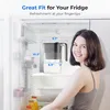 A young woman is holding a water filter pitcher in a refrigerator. The pitcher has dimensions labeled on it. Náhled obrázku produktu