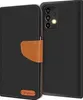 A black flip case for a Samsung Galaxy A53 5G phone is shown, with a brown leather accent and a small logo. Náhľad obrázku produktu