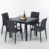 A black square table with four black chairs, set up for an outdoor dining scene. Produktbild-Vorschau