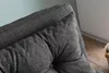 A close-up view of a dark gray upholstered sofa cushion. Náhled obrázku produktu