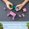 Hands assembling LEGO Minecraft figures on a gray surface, with a background graphic of Minecraft scenery. Anteprima dell’immagine prodotto