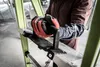 A person wearing work gloves is holding onto a handle on a ladder. Podgląd zdjęcia produktu