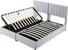A grey upholstered bed frame with the mattress support slats lifted to reveal storage space underneath. Produktbild-Vorschau