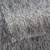 A close-up view of a textured carpet with a striped pattern. Produktbild-Vorschau