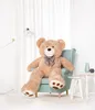 A large teddy bear sits in a chair in a well-lit room with white curtains. Podgląd zdjęcia produktu