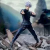 A figure of Satoru Gojo from Jujutsu Kaisen in a dynamic pose, standing amidst rubble and debris, with a blurred background of traditional Japanese architecture and mountains. Produktbild-Vorschau