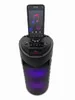 A black portable Bluetooth speaker with a smartphone docked on top, displaying a music app. Produktbild-Vorschau