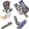 A collage of images showing different parts and configurations of a Dyson toy vacuum cleaner. Voir les images du produit