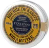 A close-up, top-down view of a round metal tin of L'Occitane Shea Butter. Voir les images du produit