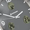 A close-up view of a modern wall clock with digital displays for temperature and humidity. Produktbild-Vorschau