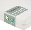 A close-up view of a white mattress with a product information band wrapped around it. Produktbild-Vorschau