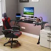 A gaming desk setup with a chair, computer, and accessories in a room. Náhľad obrázku produktu