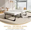 A folding bed with a mattress and a blanket in a room. Voir les images du produit