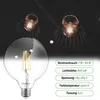 A large clear glass LED bulb is shown in the foreground, with two similar bulbs in decorative cages in the background. Technical specifications are listed on the right side of the image. Produktbild-Vorschau