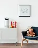 A white air purifier sits on a white cabinet next to children's toys, with a framed picture of a bear on the wall above. Anteprima dell’immagine prodotto
