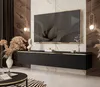 A modern living room with a wall-mounted TV cabinet and a large television.