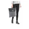 A person is holding a backpack. Produktbild-Vorschau