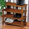 A wooden shoe rack with shoes on it, placed against a striped wall. Anteprima dell’immagine prodotto