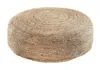A round pouf made of woven jute material on a white background.
