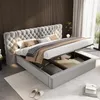 A luxurious grey upholstered bed with a tufted headboard and integrated storage is shown in a bedroom setting. Náhľad obrázku produktu