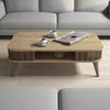 A coffee table in a living room setting with a sofa in the background. Anteprima dell’immagine prodotto