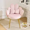 A pink velvet chair with gold legs sits on a rug in front of a white vanity table. Náhľad obrázku produktu