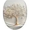 A toilet seat lid with a decorative design of a golden tree with white pearl-like embellishments. Produktbild-Vorschau