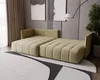 A modern living room with a beige sectional sofa, abstract art on the wall, and a large rug. Produktbild-Vorschau