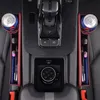 A close-up, overhead view of car interior accessories, specifically seat gap organizers with cup holders, holding cans and pens. Produktbild-Vorschau